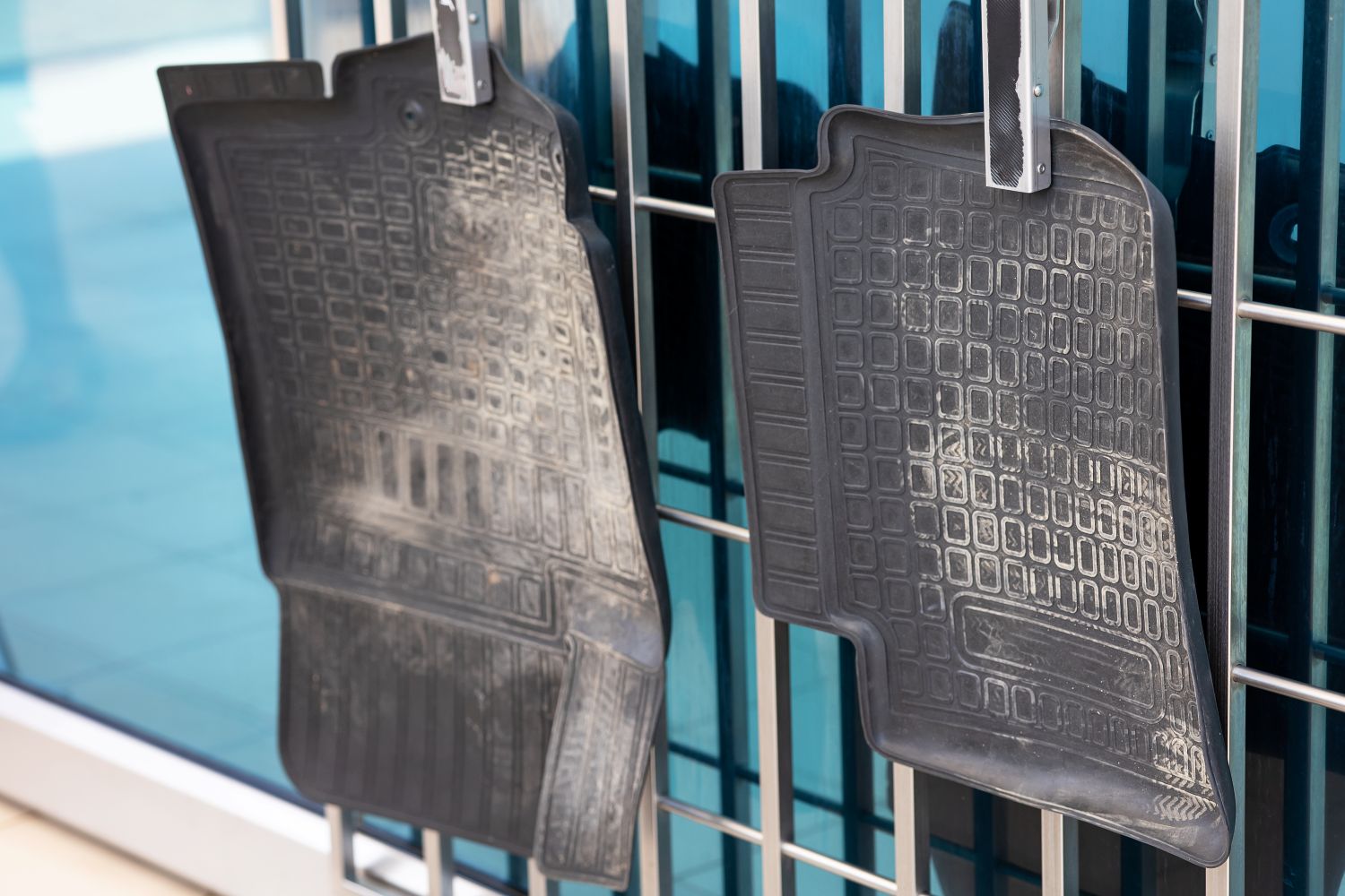 dirty rubber car floor mats hanging
